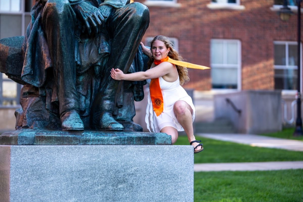 Charlotte posing playfully with the Lincoln statue